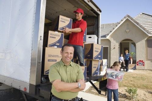 Boxes, wrapped furniture, and moving supplies ready for a Downham relocation
