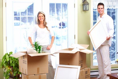 Man and van transport team handling packed boxes safely