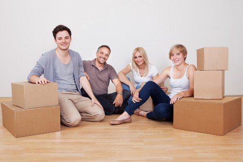 Packed moving boxes and furniture ready for transport in Downham